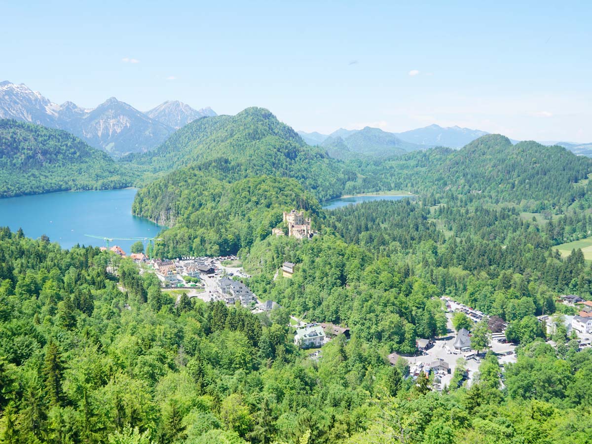 Viewpoint of Hohenschwangau Castle and the surrounding area with the town and lakes below