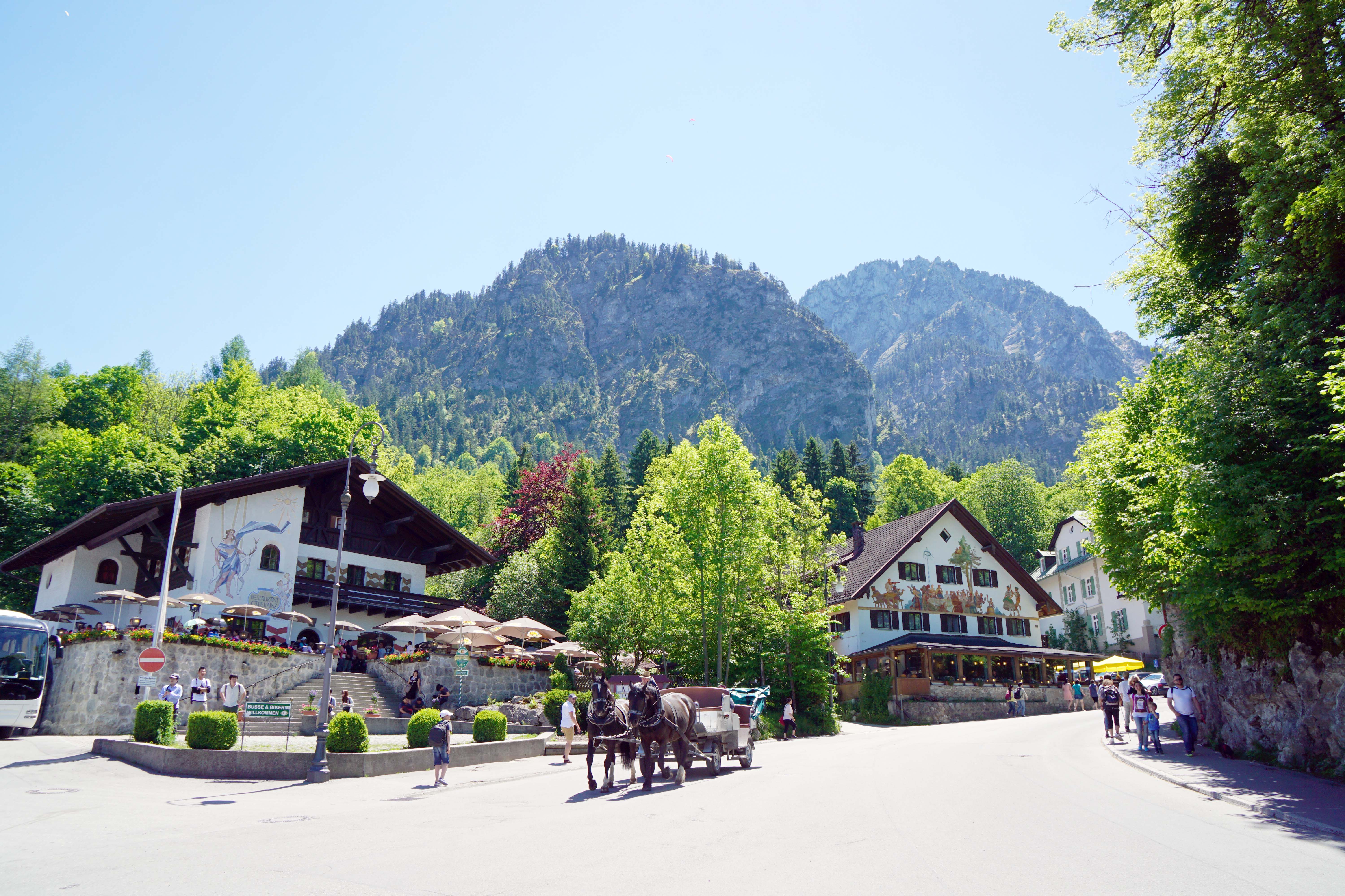 Vllage of Hohenschwangau with horse drawn carriages in the street