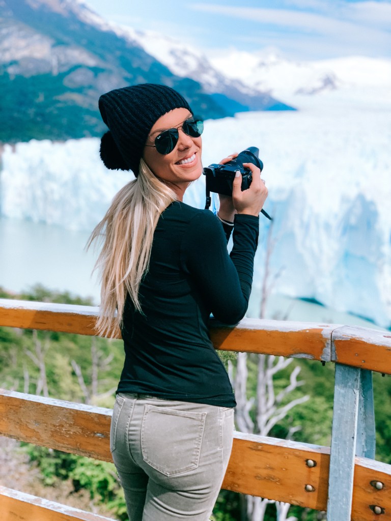 Female traveler taking photos of the Perito Moreno Glacier in the Argentine Patagonia at Los Glaciares National Park